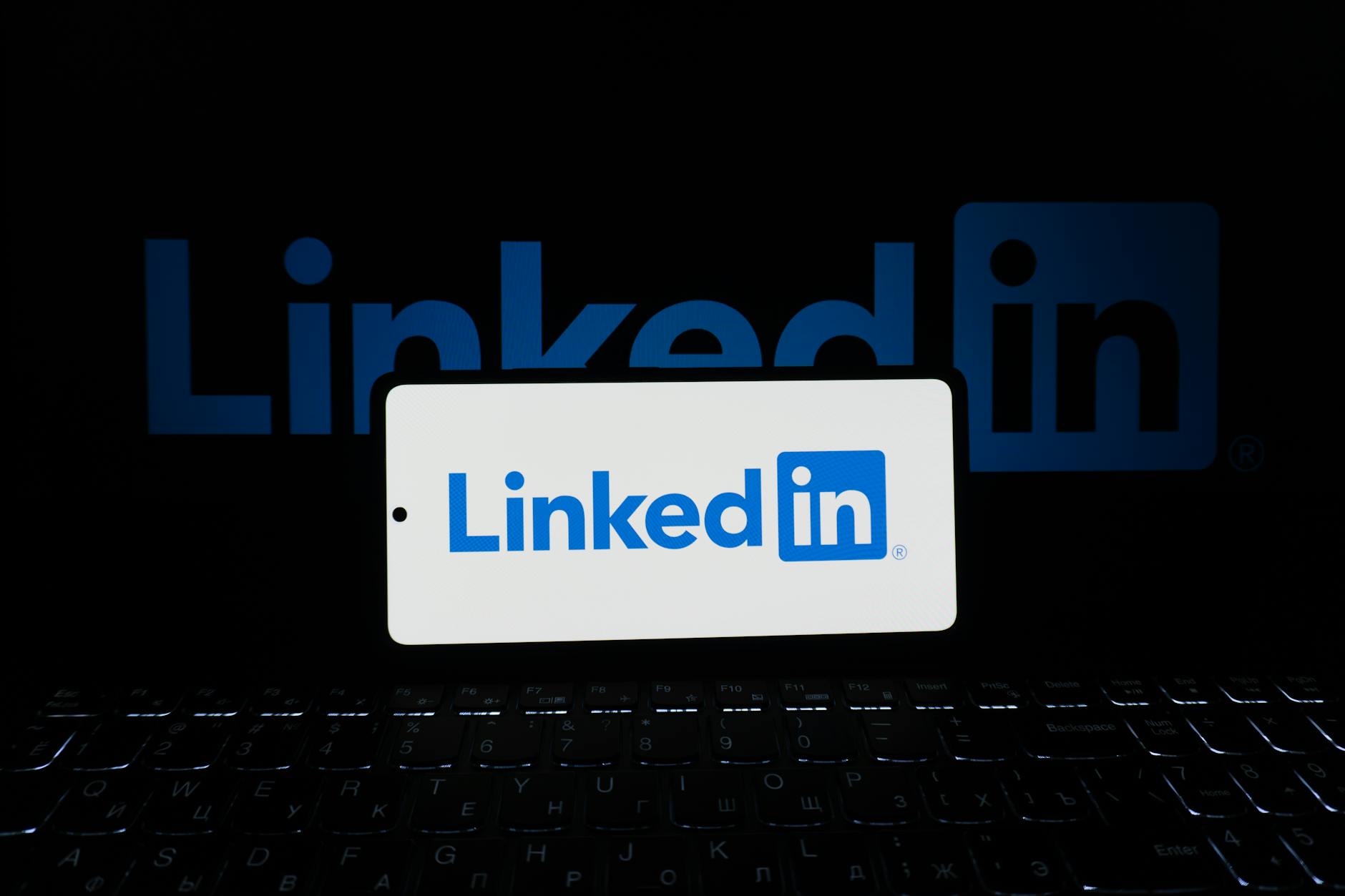 linkedin logo displayed on smartphone and laptop